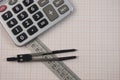 Mathematical instruments lie on a graph paper with copy space for text. Math graphic tools concept