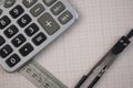 Mathematical instruments lie on a graph paper with copy space for text. Math graphic tools concept