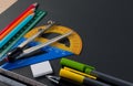 Mathematical instruments over the corner of black paper with copy space for text.