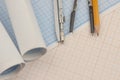 Mathematical instruments over the corner of a math graph paper with copy space for text. Math graphic tools concept
