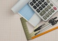 Mathematical instruments over the corner of a math graph paper with copy space for text. Math graphic tools concept