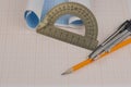 Mathematical instruments over the corner of a math graph paper with copy space for text. Math graphic tools concept