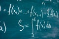 Mathematics function integra formulas written by chalk on the chalkboard.