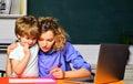 Mathematics for kids. Little boy studying, doing homework with mother. Female teacher giving private lessons to kid at Royalty Free Stock Photo