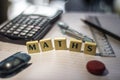 Wording of  ` MATHS ` with mathematics stationery in selective blur and close up view Royalty Free Stock Photo