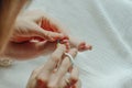 Parent hand holding scissors trimming child toenail