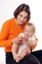 Mather in orange T-shirt with little blonde girl Royalty Free Stock Photo