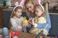 Mather and two daughter preparing Easter yellow chicken