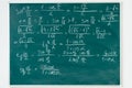 Maths formulas written by white chalk on the blackboard.