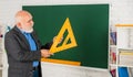 Maths Problem Solving. senior man teacher use math triangle tool. bearded tutor man at blackboard. back to school. Math Royalty Free Stock Photo