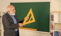 Maths Problem Solving. senior man teacher use math triangle tool. bearded tutor man at blackboard. back to school. Math Royalty Free Stock Photo