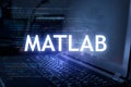 MATLAB inscription against laptop and code background. Learn programming language, computer courses, training