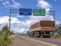 Truck on the road crosses the border between the states of Mato Grosso and Parana, with signs indicating distances in kilometers t