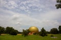 Matrimandir Golden ball Aurobindo Auroville Ashram Pondicherry with blue cloudy sky and beautiful garden Royalty Free Stock Photo