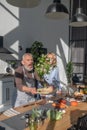 Matrure man and woman cooking together in the kitchen Royalty Free Stock Photo