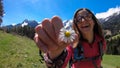 Matschacher Gupf - A woman holding daisies in her hand with panoramic view on Baeren Valley in Austrian Alps Royalty Free Stock Photo