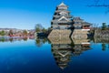 Matsumoto castle with red bridge, blue sky and reflection of the castle on the moat in Nagano Prefecture, Japan Royalty Free Stock Photo