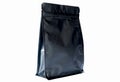 Matt black flat bottom coffee pouch with zipper filled with coffee beans on white background fron view