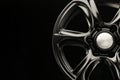 Matte black alloy wheel, close-up front view. Powerful wheel for off-road vehicles, copyspace Royalty Free Stock Photo