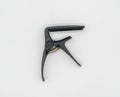 Matte black capo for acoustic and classical guitar isolated on white