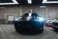 Matte black Lamborghini Urus in premium workshop with LED glare Royalty Free Stock Photo