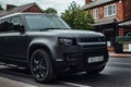 Matte black Land Rover defender car in an upmarket and posh area of Manchester.