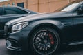 Matte black Mercedes-AMG C-class coupe side view.
