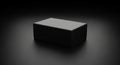 A matte black rectangular box placed on a dark surface, with soft lighting creating Royalty Free Stock Photo