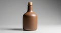 A matte brown ceramic bottle with a smooth finish is centered against a neutral gray Royalty Free Stock Photo