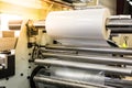 Matte or gloss plastic machine in a printing press for a perfect finish of printed documents. Royalty Free Stock Photo