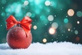matte red Christmas ball with a bow on a snowy background of bokeh lights on a Christmas tree, copy space Royalty Free Stock Photo