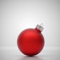 Matte red Christmas ball on light grey Royalty Free Stock Photo