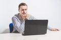 Matte toned image. young businessman working on laptop in office, being concerned Royalty Free Stock Photo