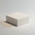 A matte white, square cardboard box with a lid rests on a smooth surface. The box has Royalty Free Stock Photo