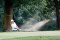 Matteo Manassero (ITA) blast out of the bunker on the 4th hole. Royalty Free Stock Photo