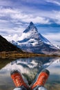 Matterhorn peak with hiking boots in Swiss Alps. Royalty Free Stock Photo