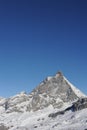 Matterhorn peak in Zermatt in winter with snow and blue sky on a sunny day in the Alps, Switzerland Royalty Free Stock Photo