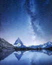 Matterhorn and reflection on the water surface at the night time. Milky way above Matterhorn, Switzerland. Royalty Free Stock Photo