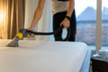 Mattress cleaning process. Man cleans bed from dirt and bacteria.