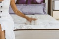 Mattress material in the hands of a woman. Pocket independent spring.