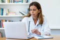 Mature adult female doctor talking online with patient Royalty Free Stock Photo