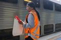 Station staff waves the white departure flag to the guard of a waiting train in Sydney Central Railway station