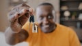 Mature african american man happy homeowner male realtor buyer showing bunch of keys from new estate apartment rented Royalty Free Stock Photo