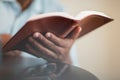 African American man praying and reading the Bible.