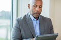 Mature African American man working on a tablet.