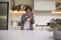 Mature African American Woman In Pyjamas At Home In Kitchen Looking At Digital Tablet Royalty Free Stock Photo