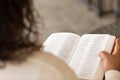 Mature African American woman sitting outside reading. Royalty Free Stock Photo