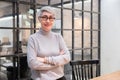 Mature age beautiful businesswoman wearing glasses standing in office Royalty Free Stock Photo