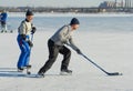 Mature amateur men playing hockey on a frozen river Dnepr in Ukraine