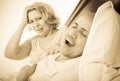 Mature angry girlfriend cannot stand guy snoring loudly Royalty Free Stock Photo